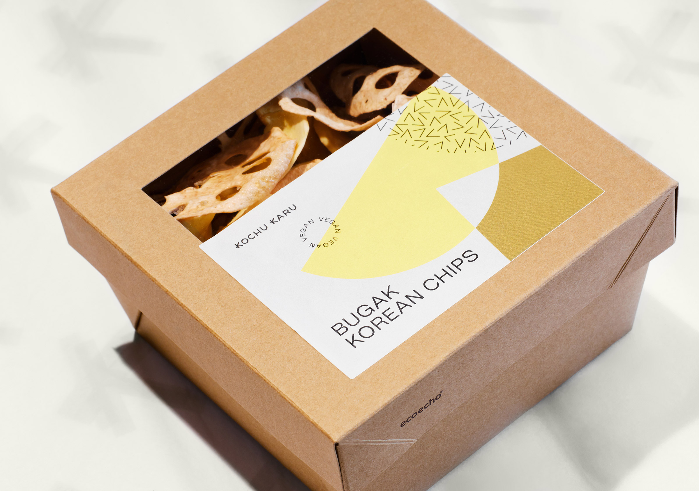 Kochu Karu Deli Korean Chips, Bugak, Produktbox aus braunem Karton mit Sichtfenster und illustrativ gestaltetem Etikett
